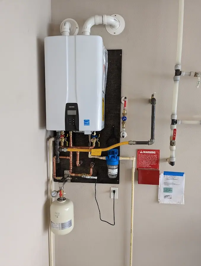 Professional plumber installing copper piping in a Oakdale home